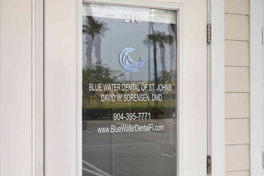 Suite 210 glass door showing the practice name, phone number and website