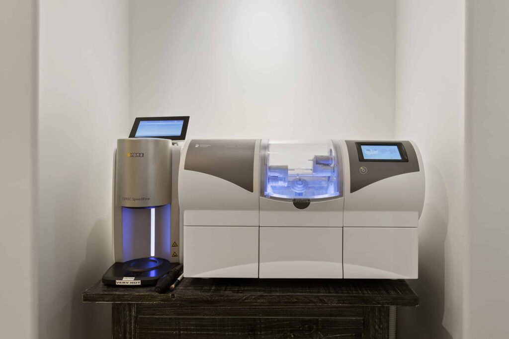 CEREC milling unit for same-day crowns on a wooden stand
