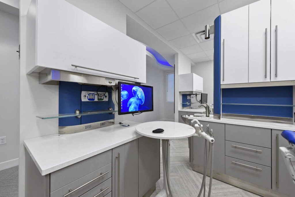 Treatment room cabinetry with a blue backsplash and small round table