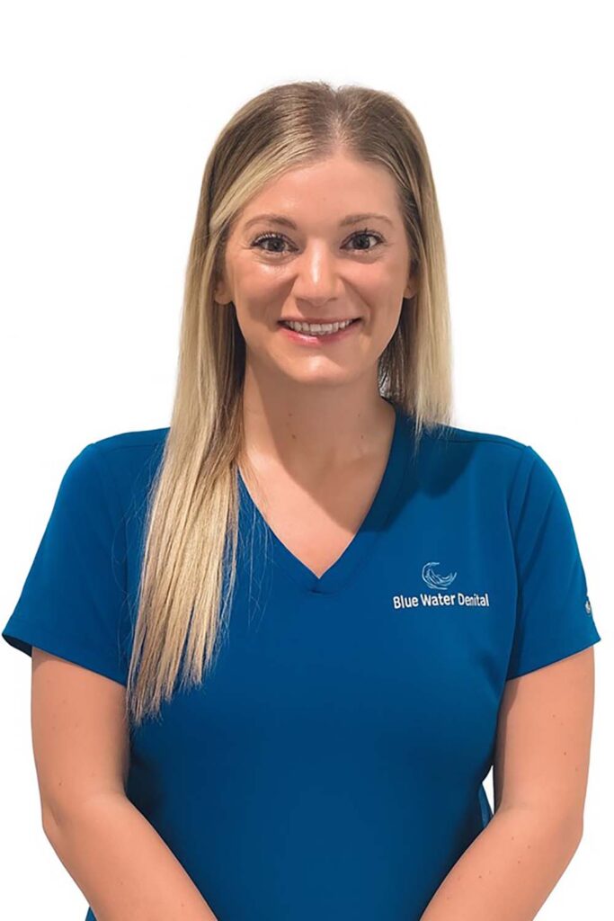 Hailey, dental assistant, in teal Blue Water Dental scrubs