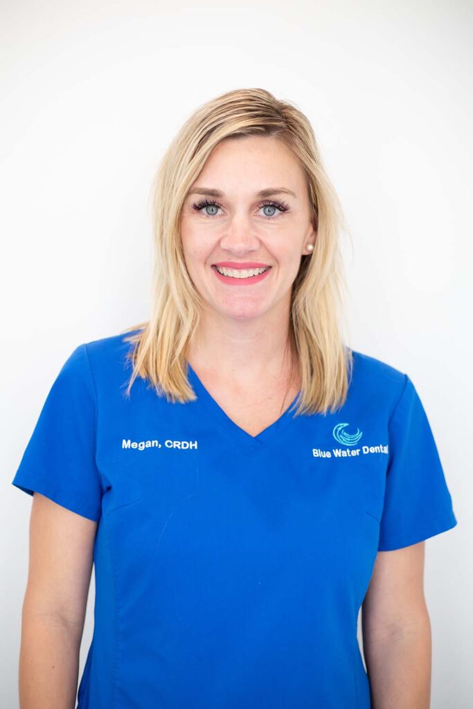 Megan, dental hygienist, in blue Blue Water Dental scrubs