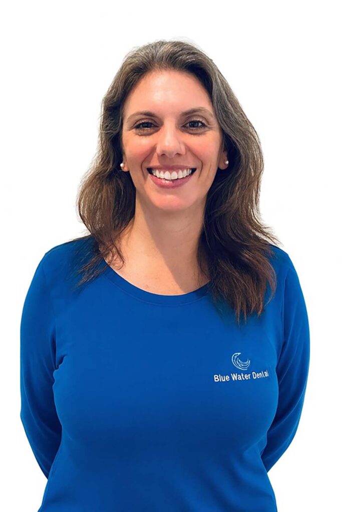 Nicole, patient benefit specialist, in a blue Blue Water Dental top